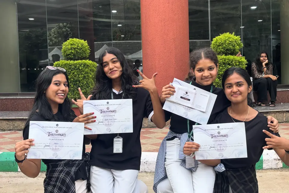 Students holding their first-place certificates from an inter-college dance competition.