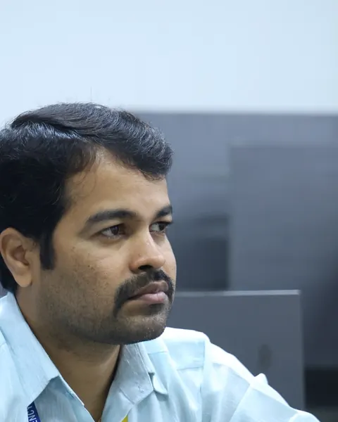 A Presidency PU teacher listening at a staff workshop.